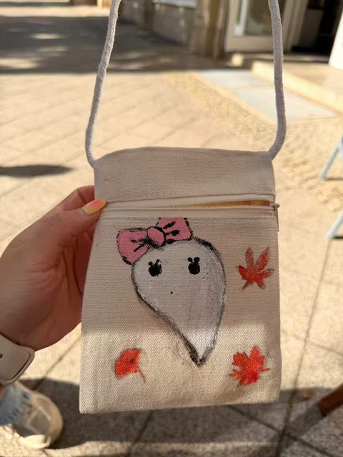 Ghost with a pink bow and autumn leaves