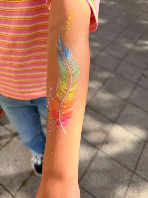Rainbow feather painted on an arm