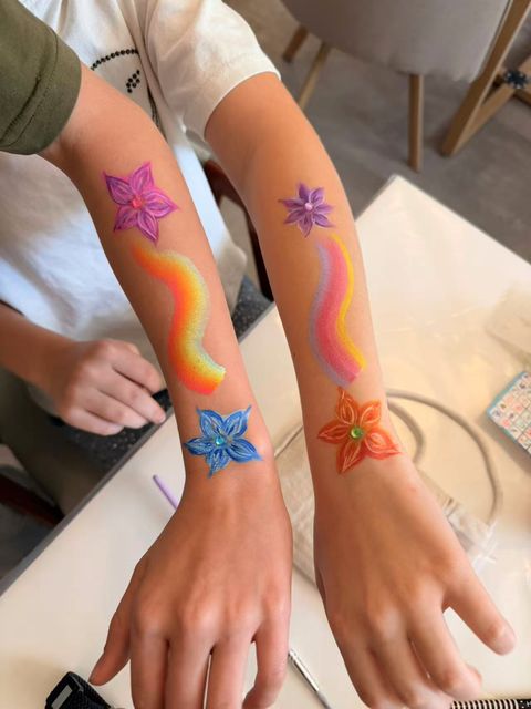 Rainbow trails with colourful stars on arms