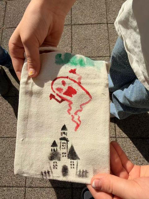 Haunted castle and red ghost painted on a bag