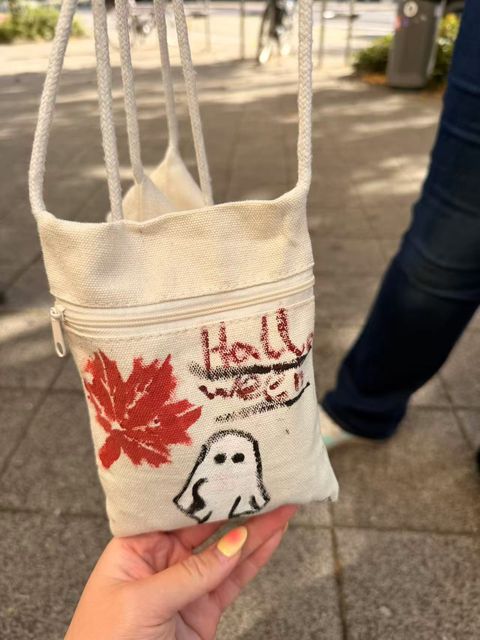 Autumn leaves and a ghost on a painted shoulder bag