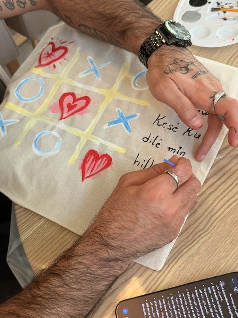 Adding lettering to a heart-themed tote bag