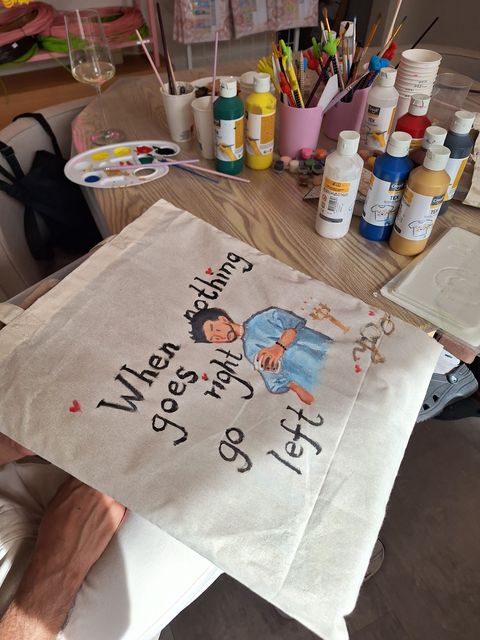 A character and playful lettering beside the workshop paints
