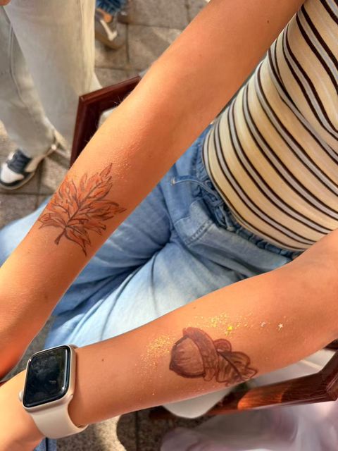 Fine line designs painted on arms