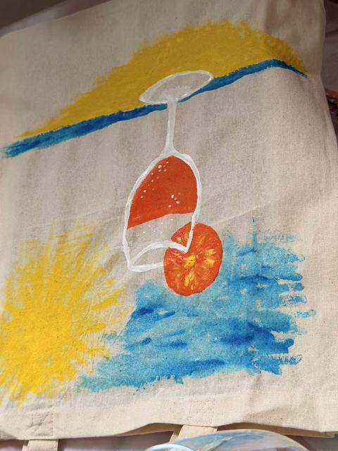 Tote bag painted with a sailing boat on the sea under a yellow sun