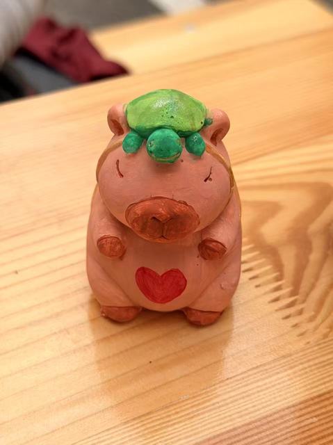 Painted plaster capybara with a small turtle on its head