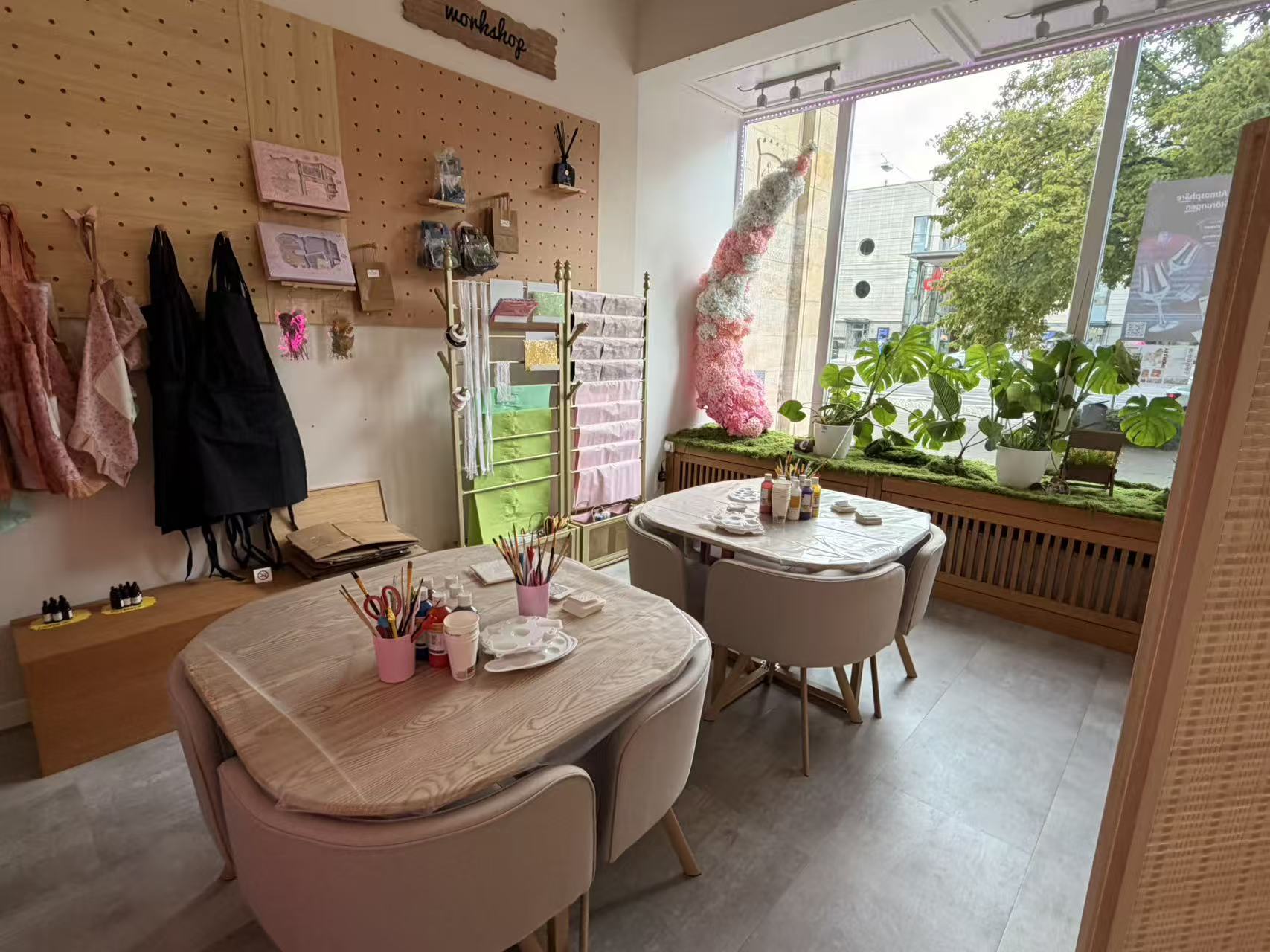 Workshop tables with brushes and paints in front of the shop window in Magdeburg